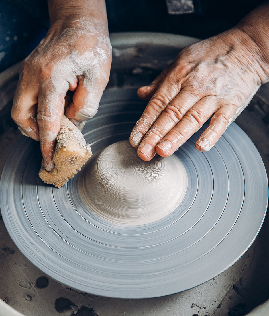 hands throwing pottery on pottery wheel