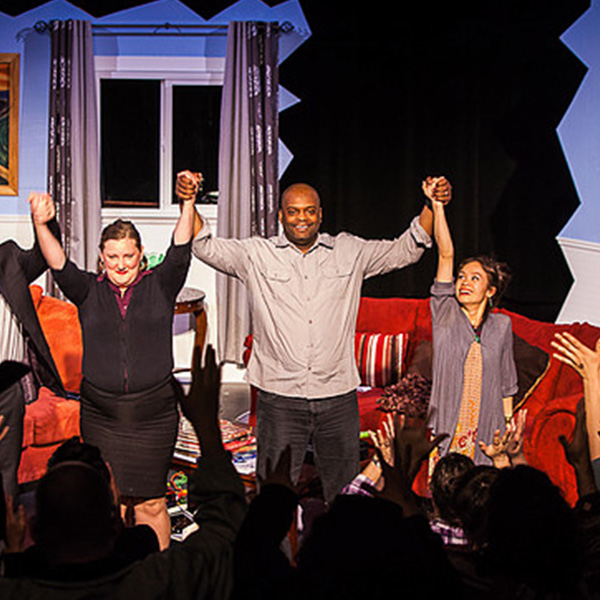 A group photo of Deaf actors taking a bow at the end of a production of "God of Carnage."